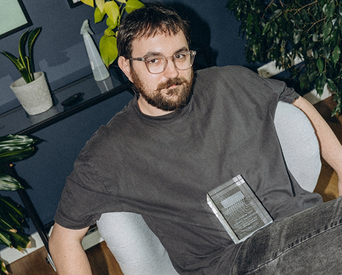 Bitnoise team member posing with an award