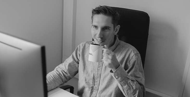 Bitnoise team member drinking coffee at his desk