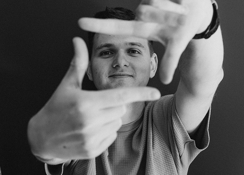 Bitnoise team member framing the camera with his hands