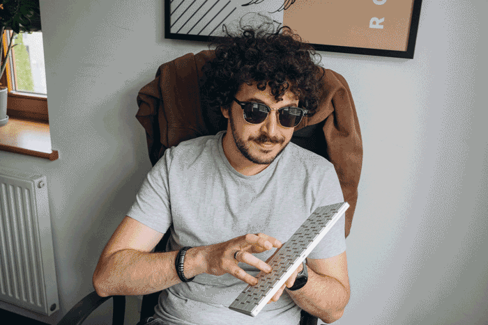 Bitnoise team member strumming a keyboard like a guitar