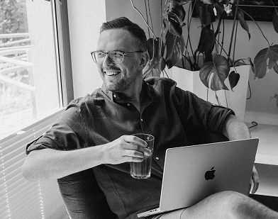 Bitnoise team member relaxing with a laptop by the window