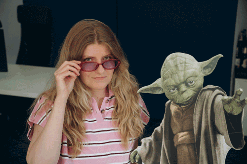 Bitnoise team member posing with a cardboard Yoda
